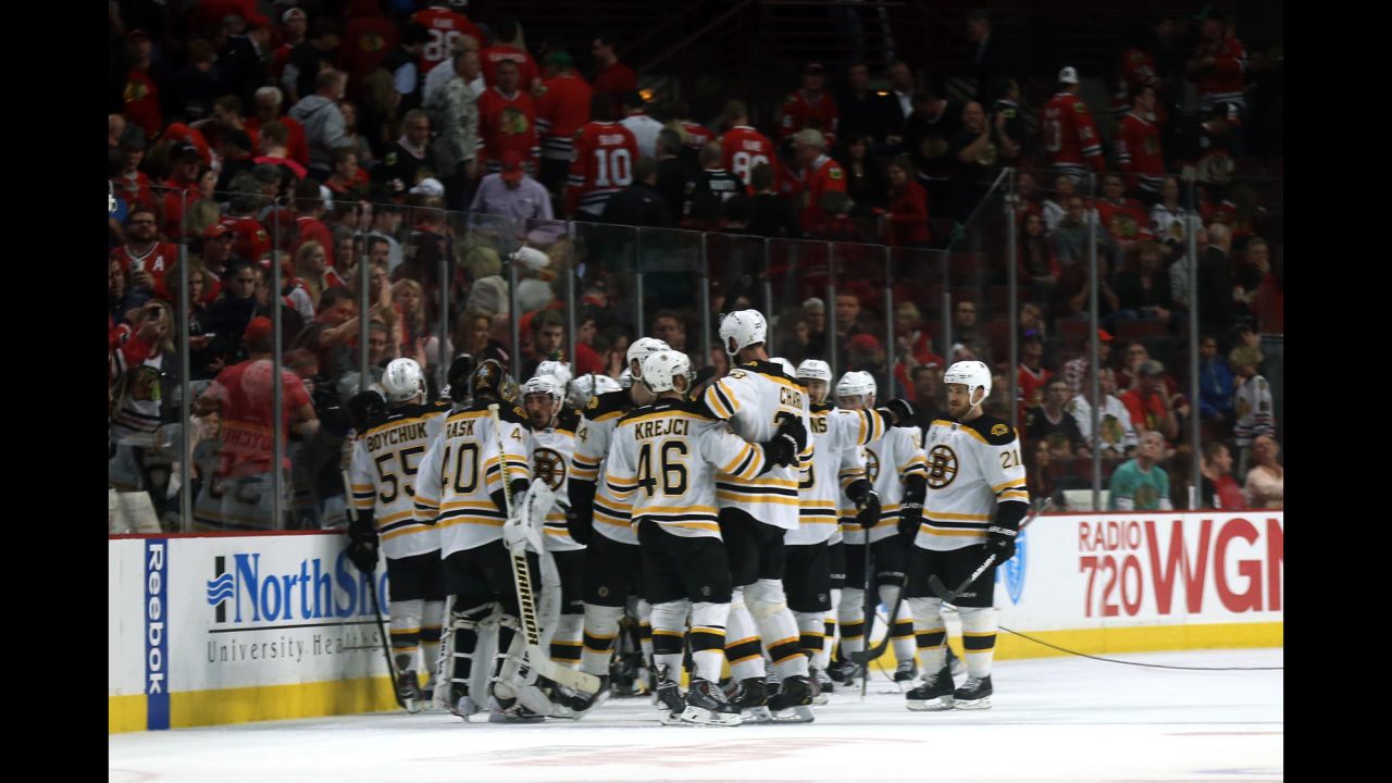 The Boston Bruins celebrate after defeating the Chicago Blackhawks in game two of the NHL 2013 Stanley Cup Final in Chicago on June 15, 2013. The  Bruins won 2-1 in overtime.