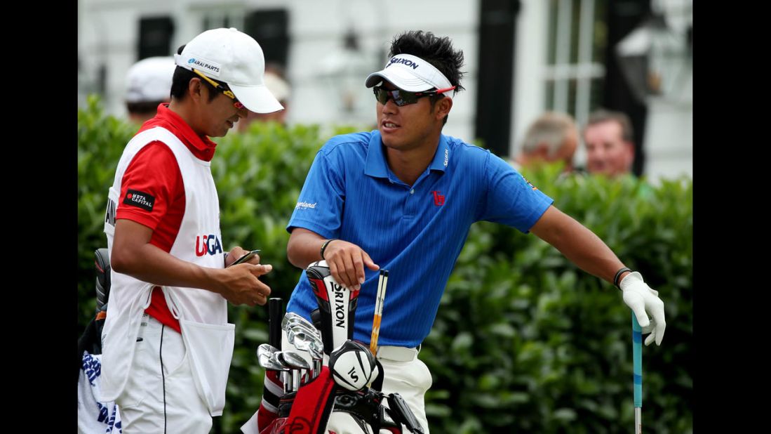 Hideki Matsuyama of Japan talks with caddie Daisuke Shindo on the first hole on June 16.