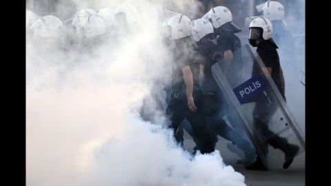 Police walk through tear gas during protests at Kizilay Square in central Ankara on June 16.
