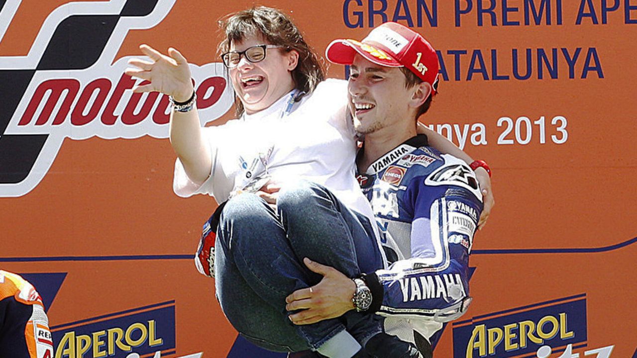Jorge Lorenzo celebrates with Anna Vives, a friend with Downs Syndrome who designed a special helmet for him. 