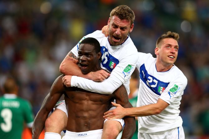 Mario Balotelli celebrates after scoring Italy's winner in the Group A match against Mexico, but was booked for taking his shirt off.