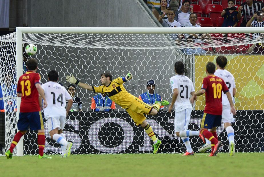 Luis Suarez, out of shot, gave Uruguay a late consolation in Recife when he curled a free-kick past Spain's goalkeeper Iker Casillas.