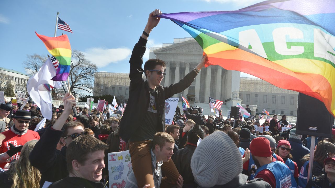 Same-sex marriage supporters demonstrate in front of the Supreme Court on March 27, 2013 in Washington, DC. The rights of married same-sex couples will come under scrutiny at the US Supreme Court on Wednesday in the second of two landmark cases being considered by the top judicial panel. After the nine justices mulled arguments on a California law that outlawed gay marriage on Tuesday, they will take up a challenge to the legality of the Defense of Marriage Act (DOMA). The 1996 law prevents couples who have tied the knot in nine states -- where same-sex marriage is legal -- from enjoying the same federal rights as heterosexual couples. AFP PHOTO/Jewel Samad (Photo credit should read JEWEL SAMAD/AFP/Getty Images)
