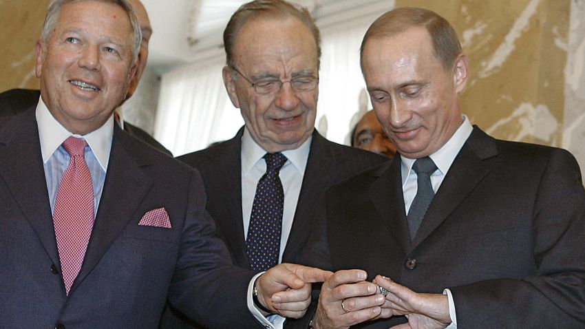 Vladimir Putin shares a laugh with Rupert Murdoch (C) and Robert Kraft (L) in St. Petersburg in 2005.