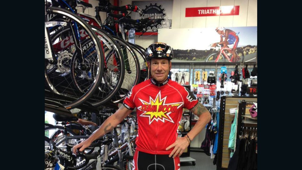 Dave Nazaroff in his bike shop in a "Team Boom" T-shirt he and his wife designed for the charity bike ride.