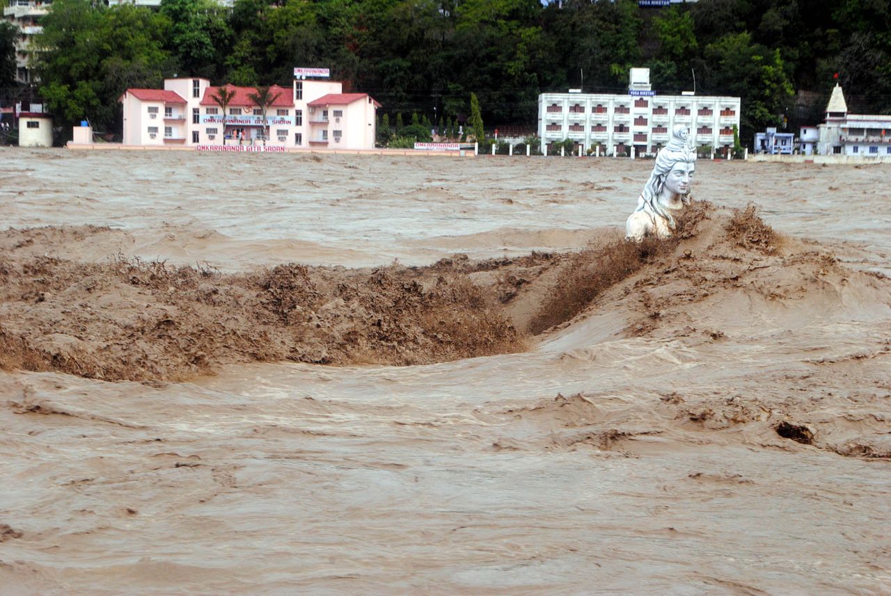Water flows over a Hindu statue during heavy monsoon rains in Rishikesh town in the state of Uttrakhand on June 17.