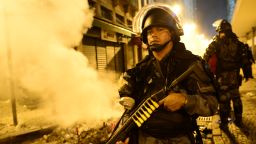 A riot police officer holds a weapon during clashes in Rio de Janeiro's downtown, on June 17, 2013.