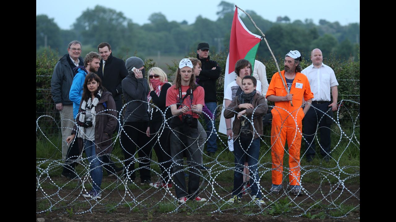 Protesters stand at the outer perimeter of the G8 summit venue at Lough Erne on June 17.