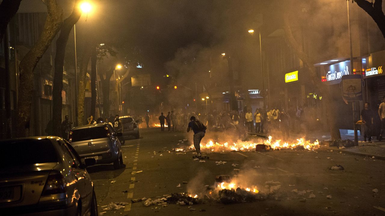 Piles of trash burn in the streets of Rio de Janeiro on June 17.