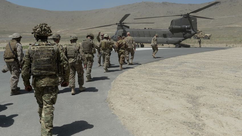 NATO soldiers board a Chinook helicopter after a security handover ceremony at a military academy outside Kabul on June 18, 2013.