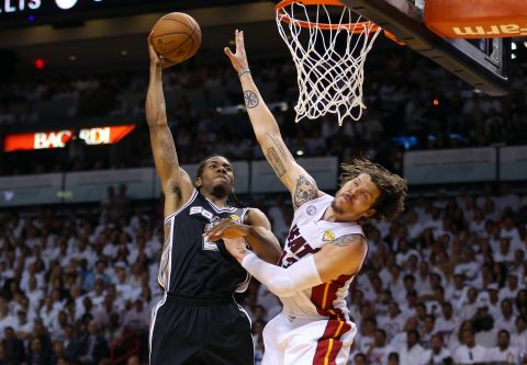 Kawhi Leonard of the San Antonio Spurs dunks on Mike Miller of the Miami Heat.
