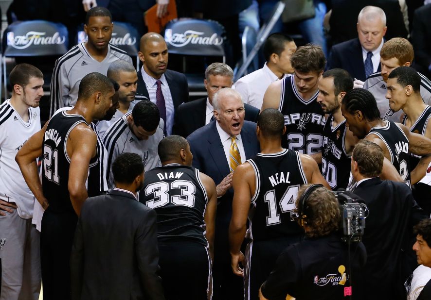 Spurs head coach Gregg Popovich coaches his team during a timeout in the first half against the Miami Heat.