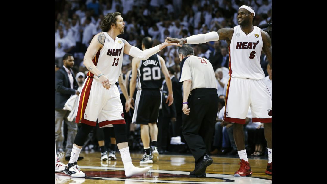 The Miami Heat's LeBron James, right, congratulates teammate Mike Miller after he hit a three-point basket wearing one shoe during the fourth quarter against the San Antonio Spurs.