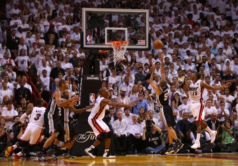 Tony Parker of the San Antonio Spurs makes a basket over Mario Chalmers of the Miami Heat near the end of the fourth quarter.