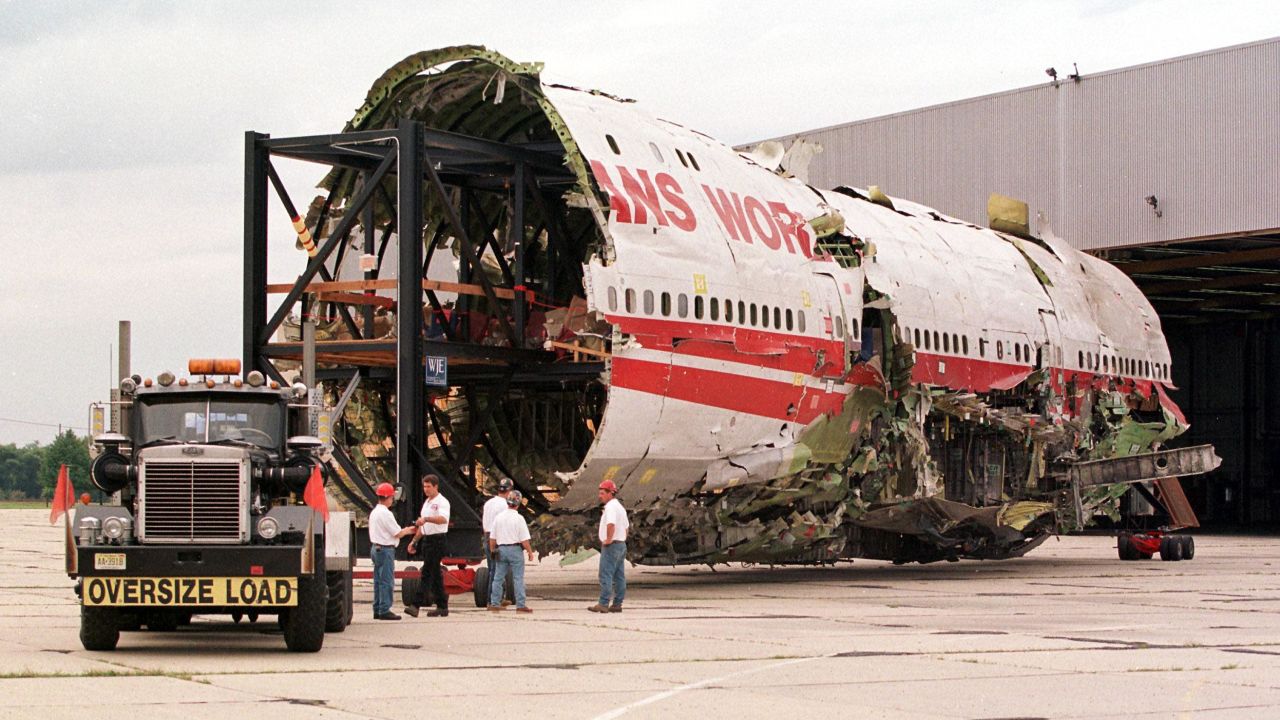 The partially reconstructed fuselage of TWA Flight 800 is pulled out of a hangar in Calverton, New York, on September 14, 1999.