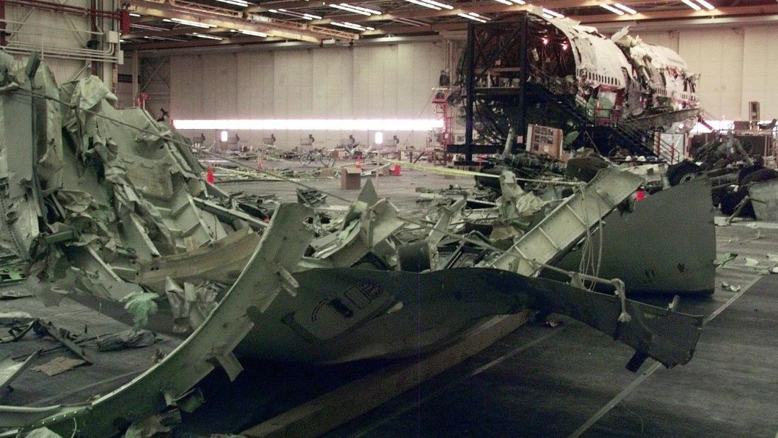 Parts of the aircraft's wing sit in the hangar on July 8, 1999, in Calverton, New York.