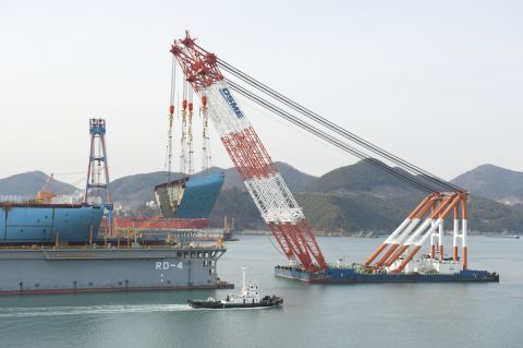 A giant crane lowers a huge section of the first Maersk Triple E into place at the Daewoo Shipbuilding and Marine Engineering shipyard in Okpo, South Korea.