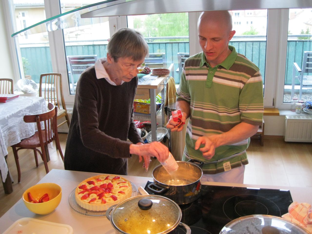 Tenant Dorothea Straube-Koberstein bakes a cake with Christoph Remmlinger, a personal care assistant, at a shared apartment for seniors in Potsdam, Germany.
