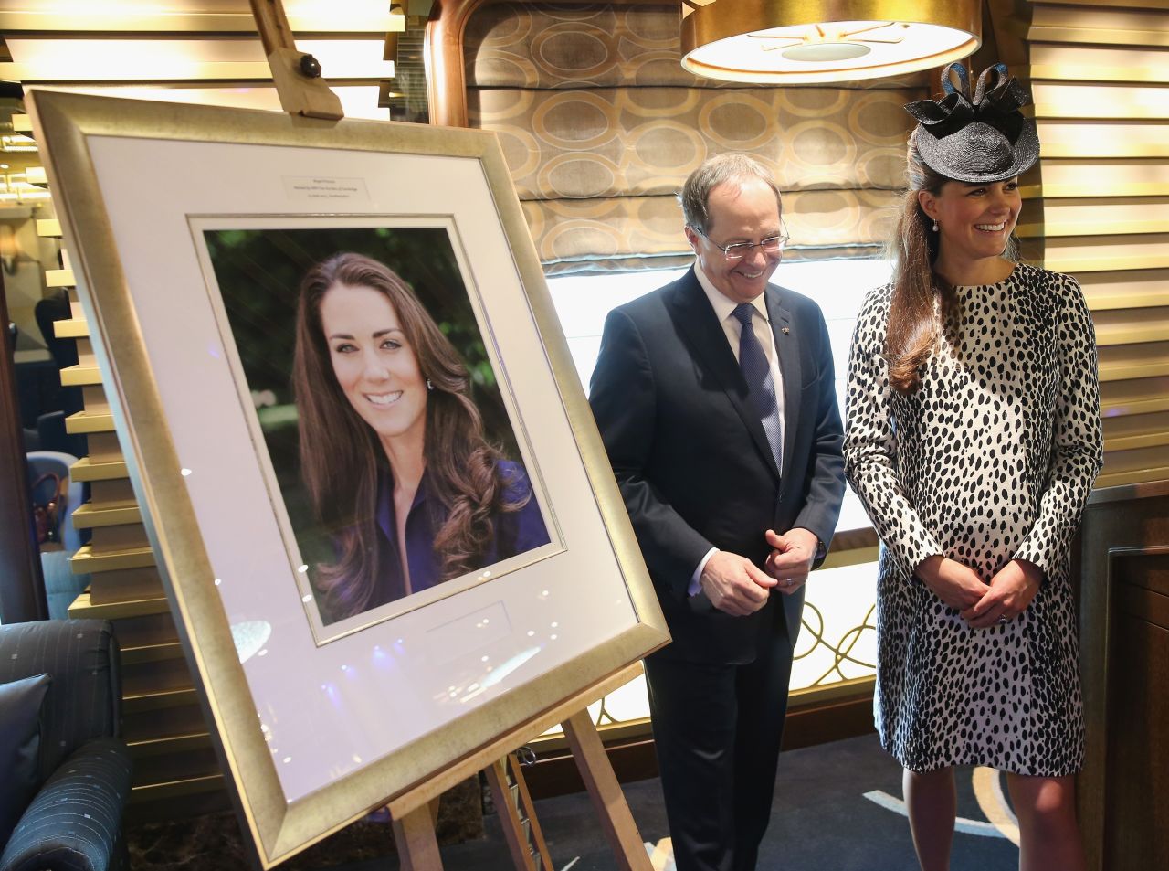 President and CEO of Princess Cruises Alan Buckelew escorts Catherine stands next to an image taken of herself by Getty photographer Chris Jackson after a ship's naming ceremony at Ocean Terminal on June 13, 2013 in Southampton. This was Catherine's final public appearance before she gives birth.