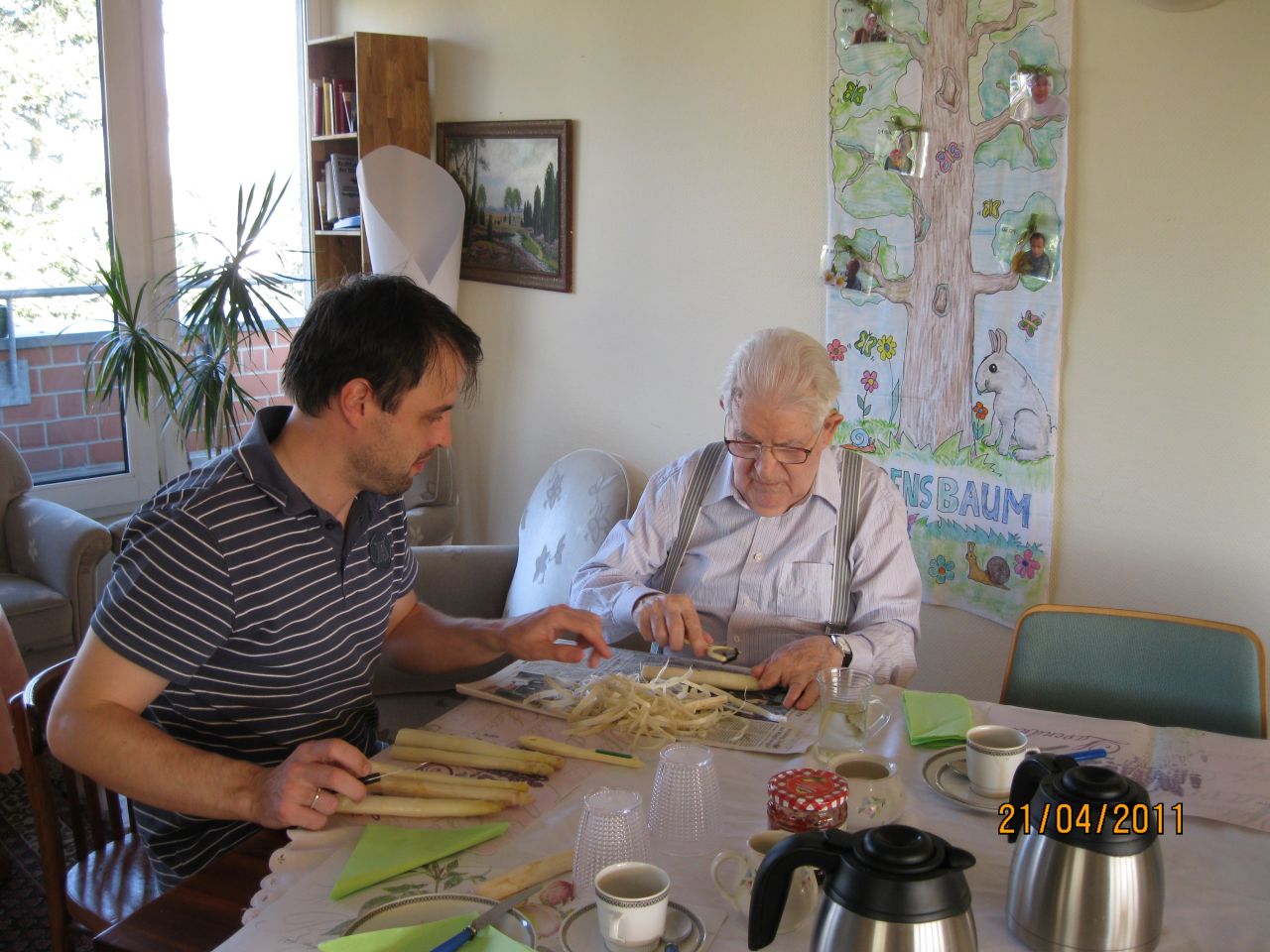 Caregiver Thomas Ganschow and resident Egon Hanss peel asparagus for dinner.