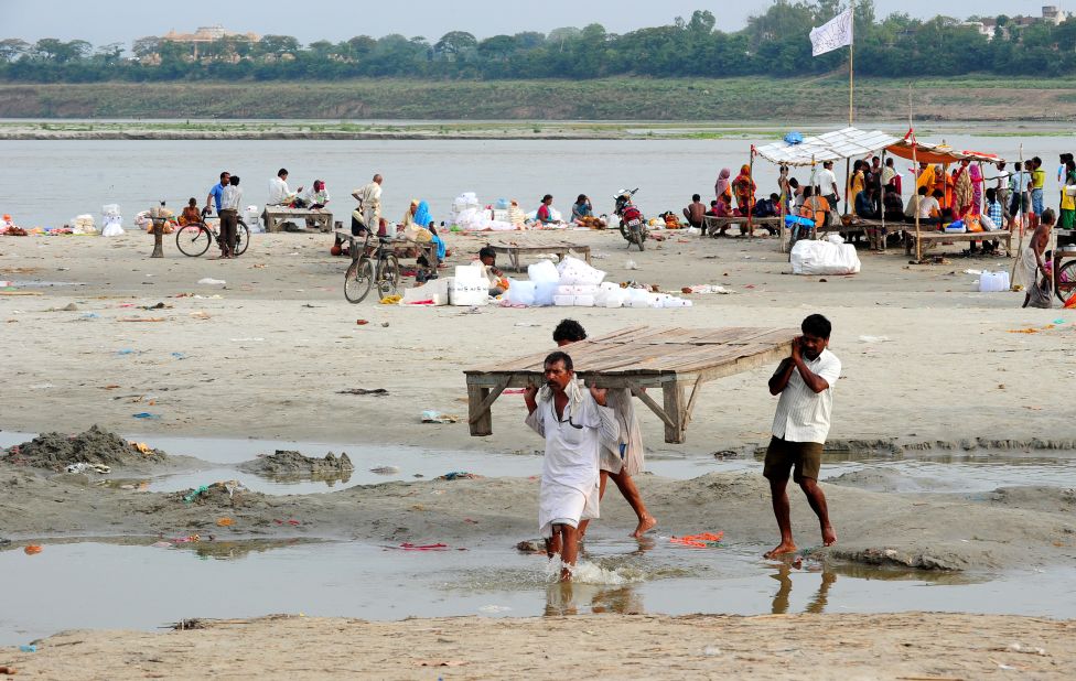 Hindu priests move their shelters from the banks of the Ganga river as the water level rises in Allahabad, Uttar Pradesh state, on June 19.