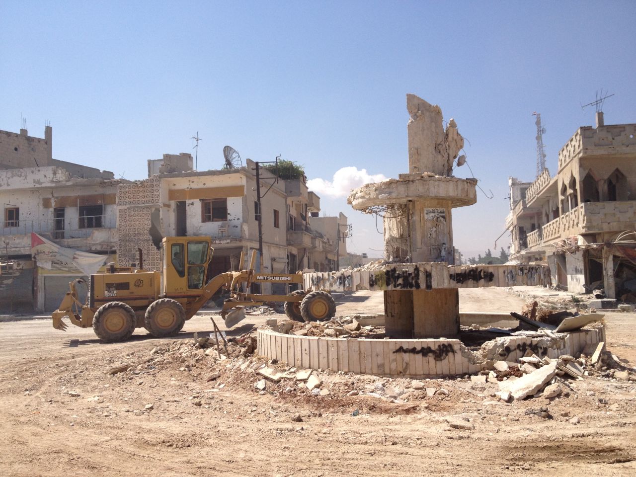 Some heavier equipment is used in clean up efforts in a central square.