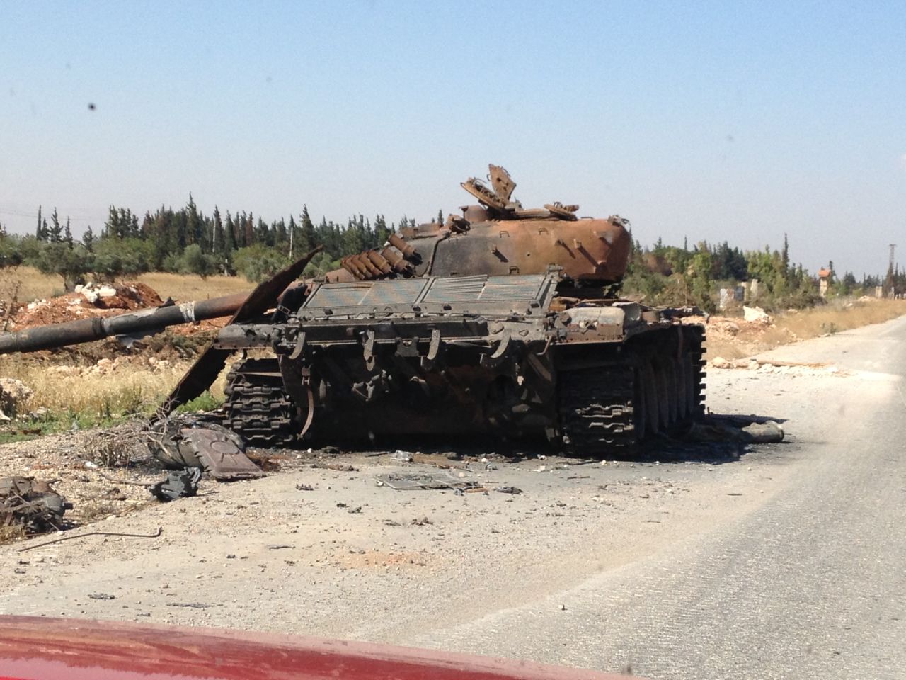 A destroyed tank is pictured at the entrance to the city.