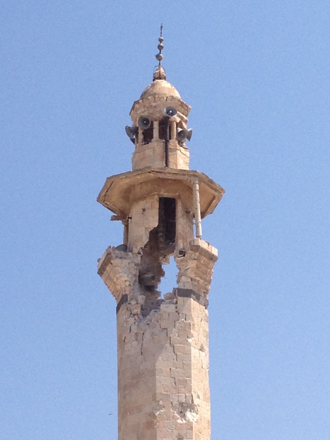 The mosque's minaret has a gaping hole after being hit by a shell. 
