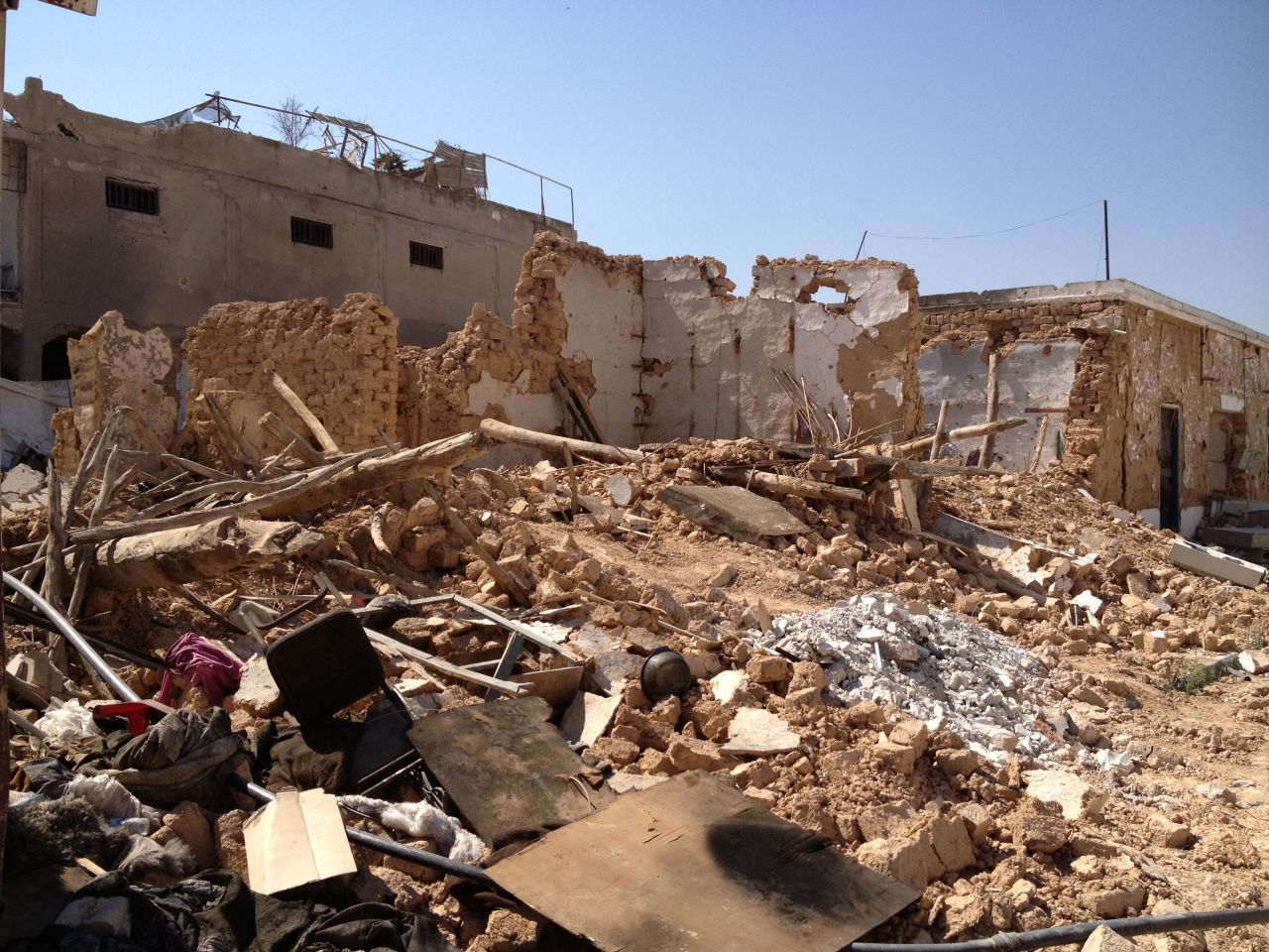 A destroyed house is pictured in the old town, where many of the buildings have been reduced to rubble.  Some people scavenged through the debris to find anything of value. 