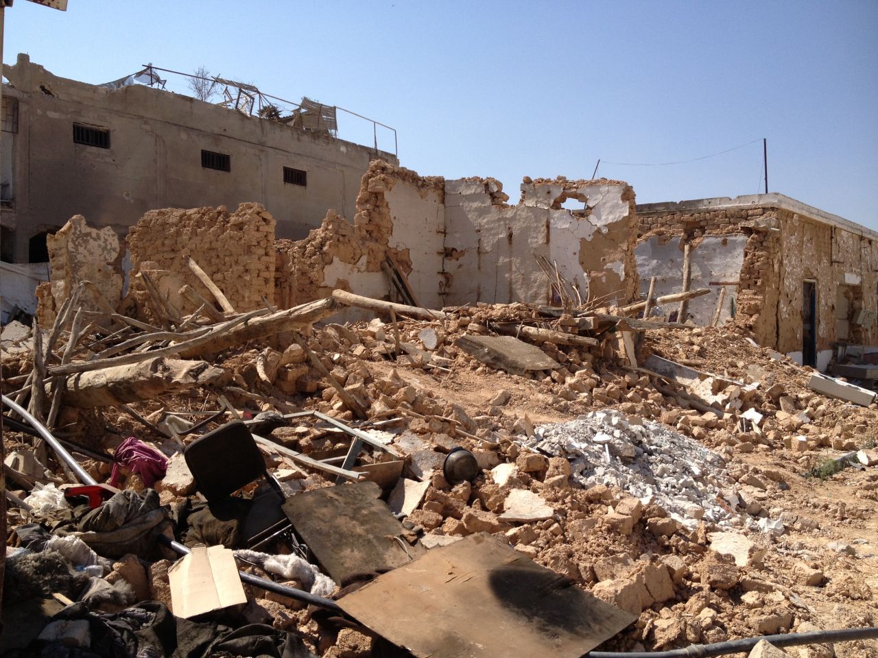 A destroyed house is pictured in the old town, where many of the buildings have been reduced to rubble. Some people scavenged through the debris to find anything of value.