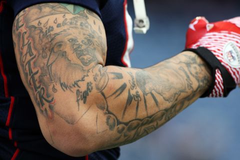 Tattoos on Hernandez's arm are visible during a pregame warmup on December 4, 2011.