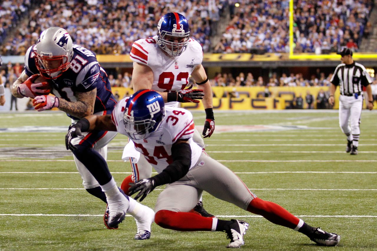 Hernandez runs for a 12-yard touchdown past Deon Grant of the New York Giants in the third quarter of Super Bowl XLVI on February 5, 2012, in Indianapolis.