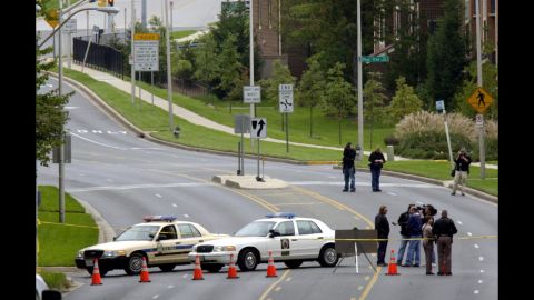 A stretch of road where 40-year-old bus driver Conrad Johnson was shot and killed is blocked off in Aspen Hill, Maryland, on October 22, 2002. Johnson was the last victim of the Beltway sniper attacks.