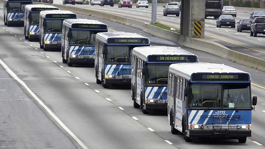 A motorcade of buses bearing the name of driver Conrad Johnson, the last victim of the three-week shooting rampage, travels on the Beltway to Johnson's funeral in Washington on October 26, 2002.