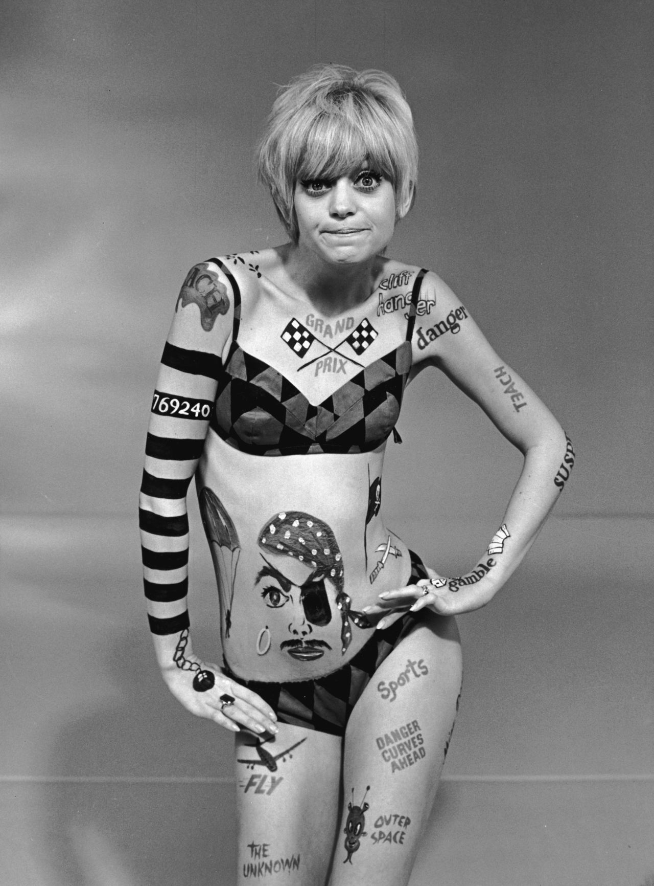 By the end of the decade, California beach style took a psychedelic spin with graphic prints and barely-there bikinis. Body paint, as worn by Goldie Hawn on "Laugh-In," rounds out the look.