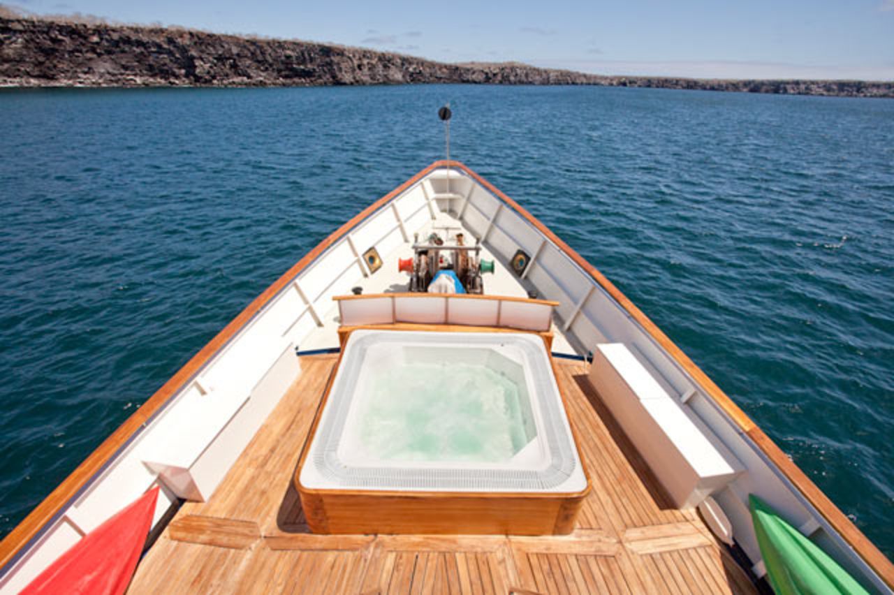 Today, the luxurious boat has been refitted with nine staterooms and a top-deck hot tub. Guests can enjoy fine dining as the yacht winds its way around the exotic Galapagos Islands. 