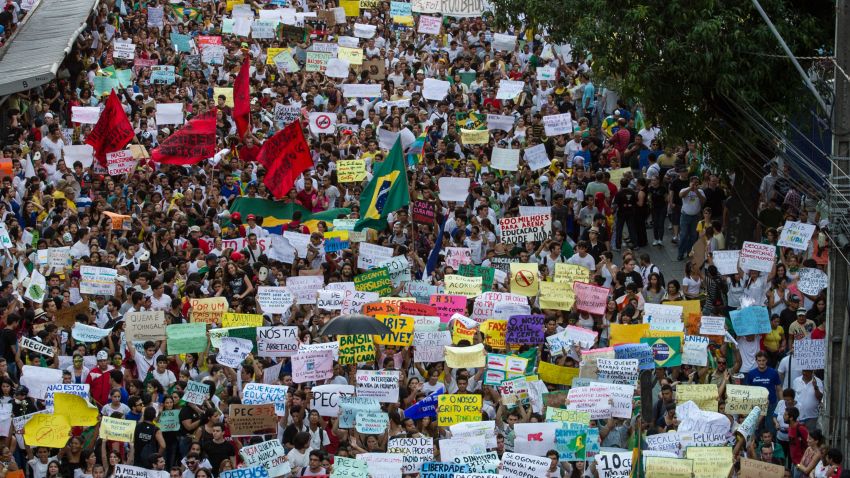 Thousands of people march in the center of Recife, state of Pernambuco, Brazil, on June 20, 2013, during a protest of what is now called the 'Tropical Spring' against corruption and price hikes. Brazilians took to the streets again on a new day of mass nationwide protests, demanding better public services and bemoaning massive spending to stage the World Cup. More than one million people have pledged via social media networks to march in 80 cities across Brazil, as the two-week-old protest movement -- the biggest seen in the South American country in 20 years -- showed no sign of abating. AFP PHOTO / YASUYOSHI CHIBA (Photo credit should read YASUYOSHI CHIBA/AFP/Getty Images)