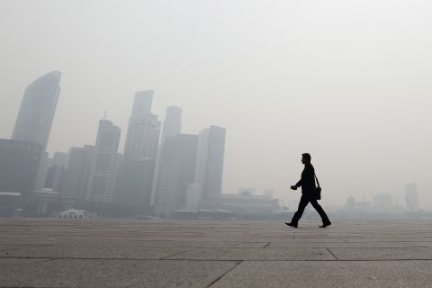 A man cut a striking figure against Singapore's hazy skyline on June 20.