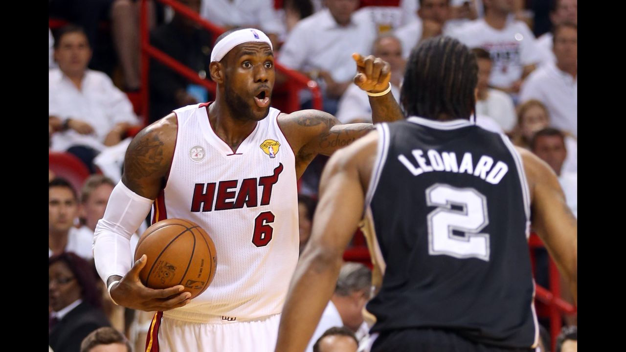   LeBron James of the Miami Heat calls a play against Kawhi Leonard of the San Antonio Spurs in the first quarter of game 7.