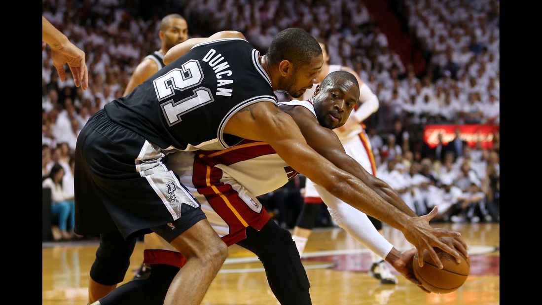  Dwyane Wade of the Miami Heat looks to pass the ball against Tim Duncan of the San Antonio Spurs.