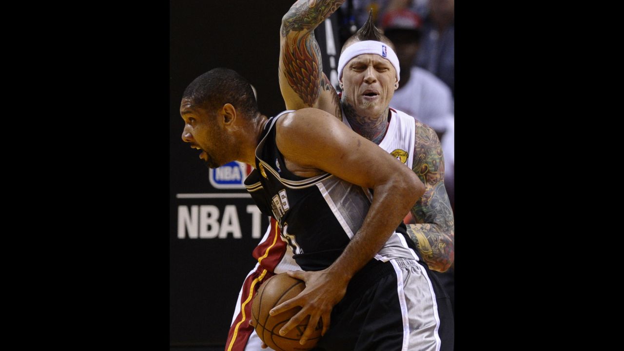 Chris Andersen of the Miami Heat guards Tim Duncan of the San Antonio Spurs.