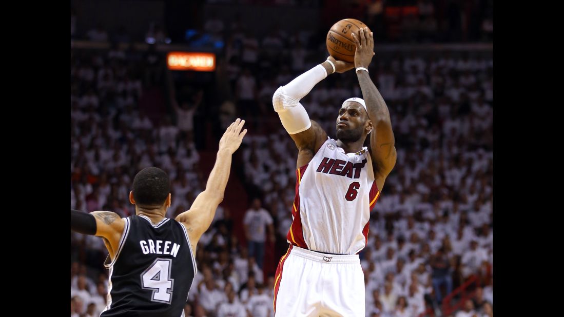 LeBron James of the Miami Heat makes a three-pointer over Danny Green of the San Antonio Spurs in the second quarter.