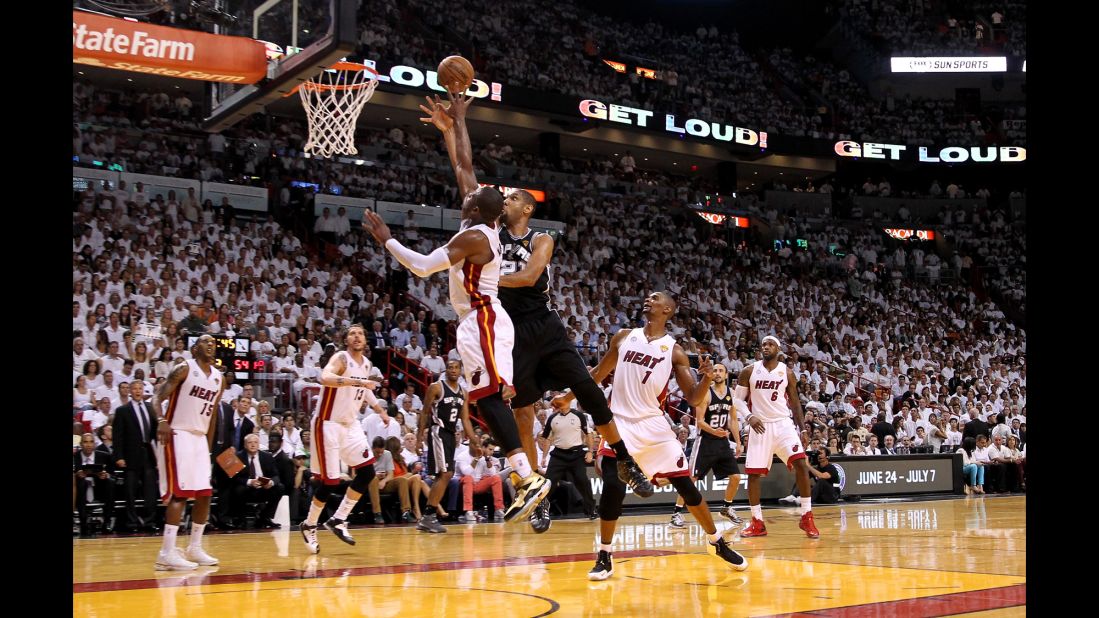 Tim Duncan of the San Antonio Spurs shoots the ball over Dwyane Wade of the Miami Heat in the third quarter.