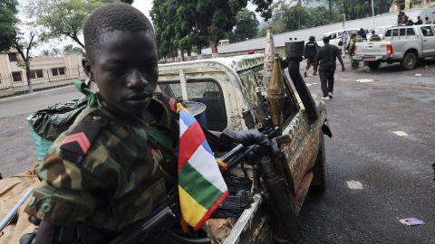 A child soldier in the Central African Republic sits on a truck near the Presidential palace in Bangui on March 25, 2013.  