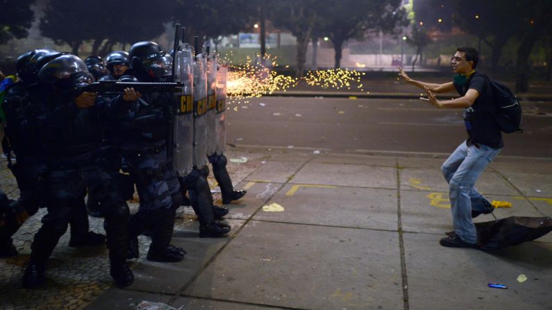 Police fire rubber bullets at a protester during clashes in Rio de Janeiro on Thursday, June 20. Demonstrations in Brazil began in response to <a href="index.php?page=&url=http%3A%2F%2Fwww.cnn.com%2F2013%2F06%2F20%2Fworld%2Famericas%2Fbrazil-protests%2F%3Fhpt%3Dhp_t2">plans to increase fares for the public transportation system</a> but have broadened into wider protests over economic and social issues. Since then, both Sao Paulo and Rio de Janeiro have agreed to roll back prices on bus and metro tickets.<br />