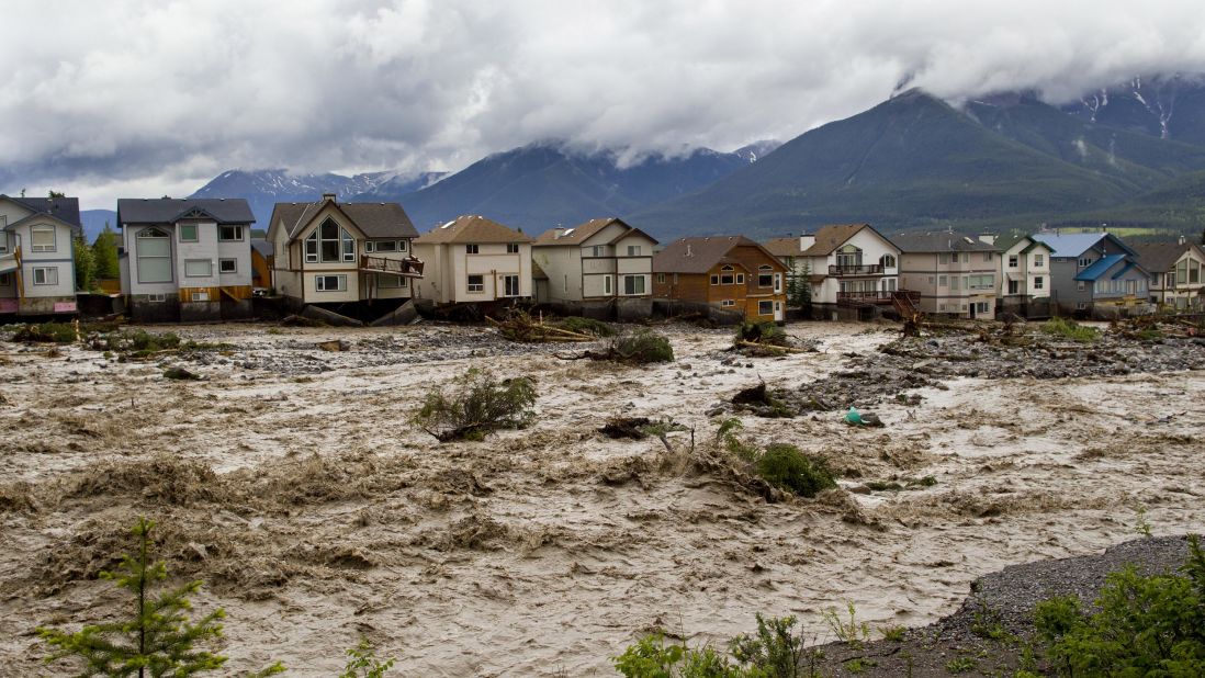 The waters of Cougar Creek expand through a neighborhood in Canmore, west of Calgary, on June 20.
