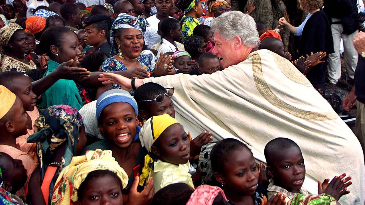 President Bill Clinton reaches out to shake hands while touring Ushafa, Nigeria, on August 27, 2000.