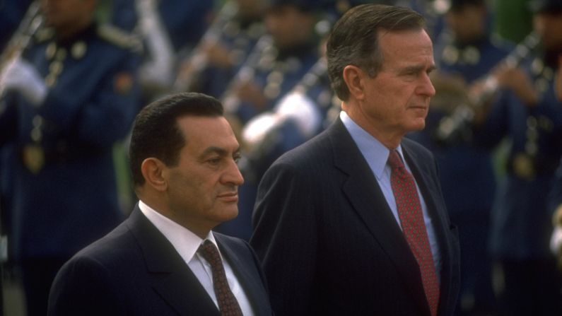 Former Egyptian President Hosni Mubarak and President George H.W. Bush stand together at a ceremony in Cairo, Egypt, on November 24, 1990.