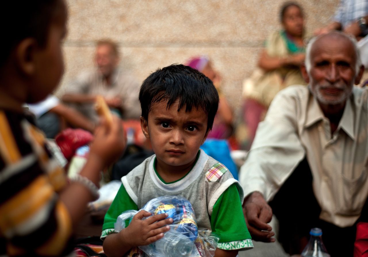 Severe flooding has left more than 50,000 people stranded in northern India. A boy rescued from flood-hit areas waits with others before being sent to relief camps in Dehradun, state capital of Uttarakhand, on Friday, June 21.