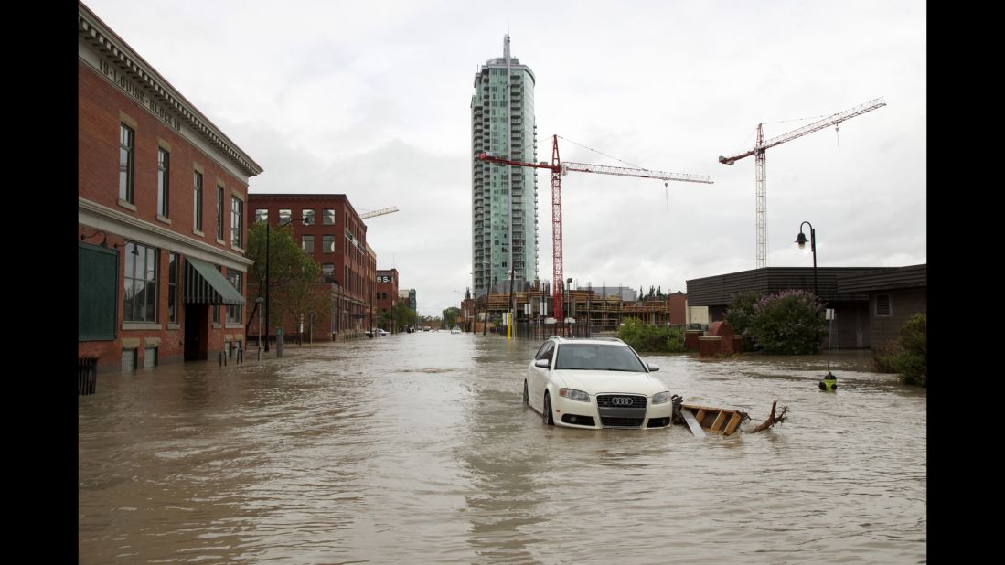 A car sits on a flooded street in Calgary on June 21.